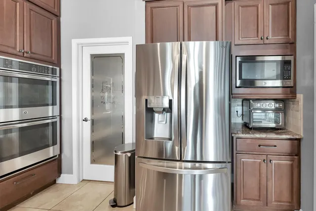 a view of a kitchen with cabinets and fireplace