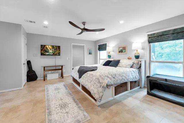 a bedroom with bed and a window