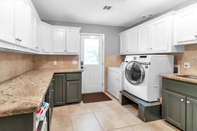 a view of a patio with table and chairs under an umbrella with wooden floor
