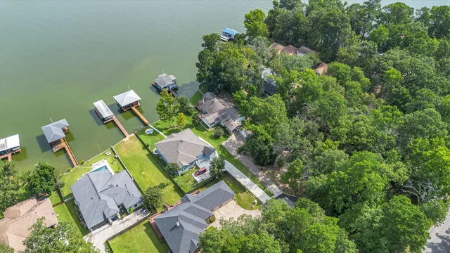 an aerial view of a house with a yard basket ball court