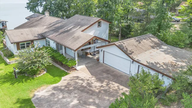 a aerial view of a house with a yard and potted plants