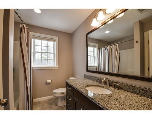 7 Willow Road Ashland, MA 01721 - Photo 24 of 32 a bathroom with a granite countertop sink toilet a large mirror and a shower