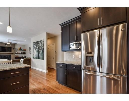 7 Willow Road Ashland, MA 01721 - Photo 5 of 32 a kitchen with stainless steel appliances kitchen island granite countertop a refrigerator a stove a sink and a refrigerator