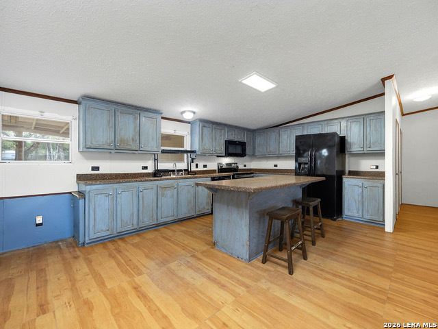 135 Savannah Ridge Von Ormy, TX 78073 - Photo 33 of 45 a kitchen with a sink a counter top space stainless steel appliances and cabinets