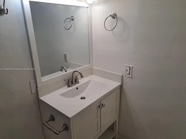 a bathroom with a sink and mirror