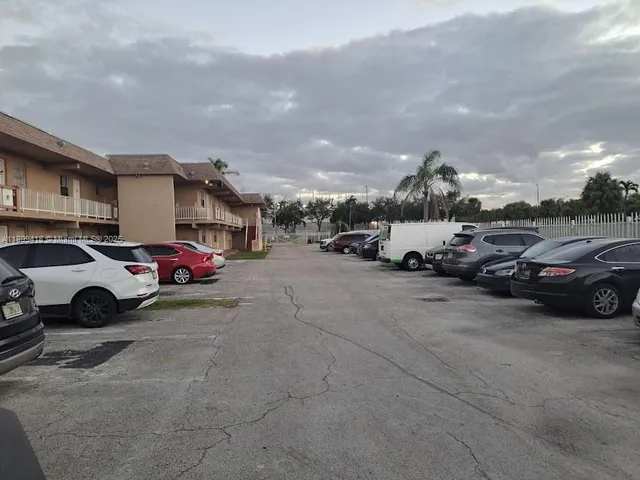 a view of cars parked in front of a building