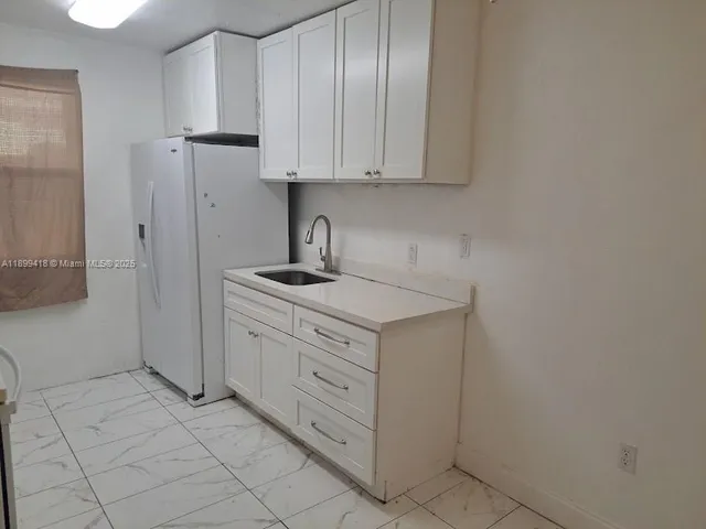 a kitchen with cabinets and appliances