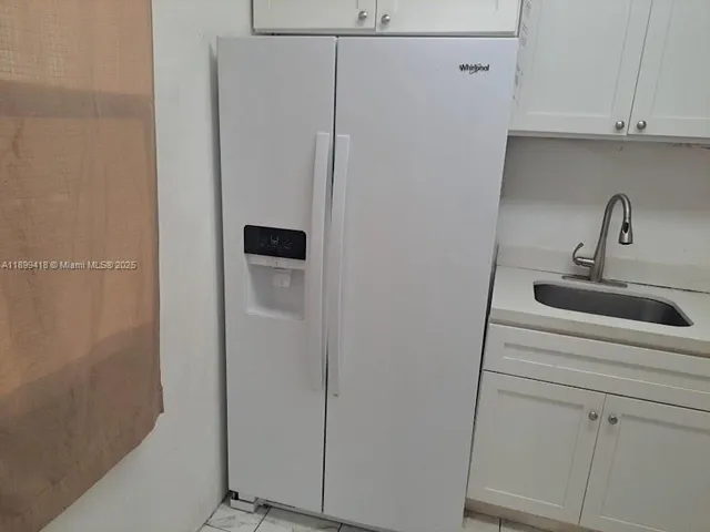 a close view of a sink and cabinets in the kitchen