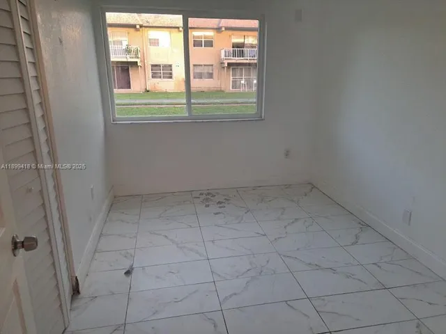 an empty room with a empty space and window