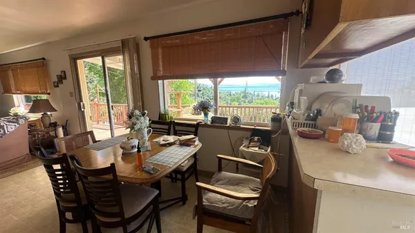 a dining room with furniture a chandelier and wooden floor