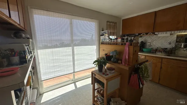 a view of a kitchen with a table and chairs in it