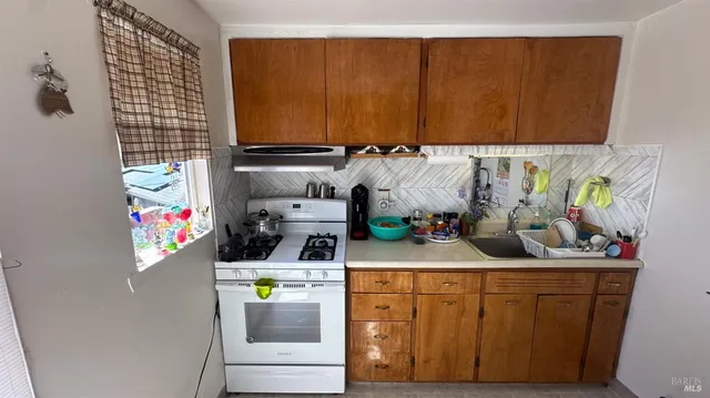 a kitchen with stainless steel appliances kitchen island granite countertop a sink and cabinets
