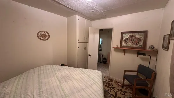 a bedroom with a bed and a chair