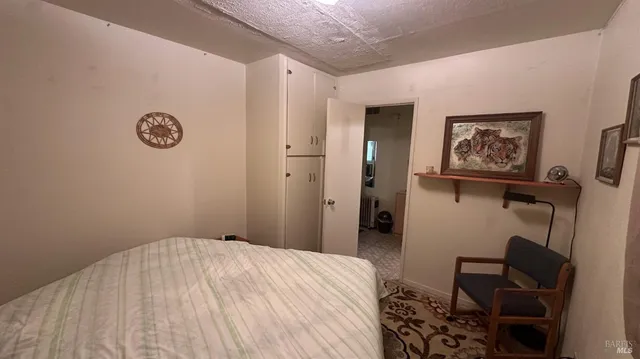 a bedroom with a bed and a chair