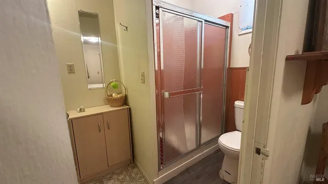 a bathroom with a shower a toilet and a sink