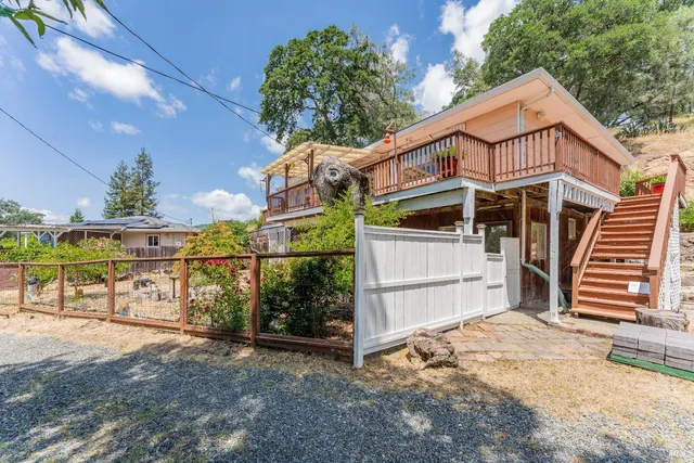 a view of a house with wooden fence