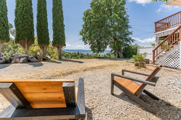 a view of a backyard with sitting area