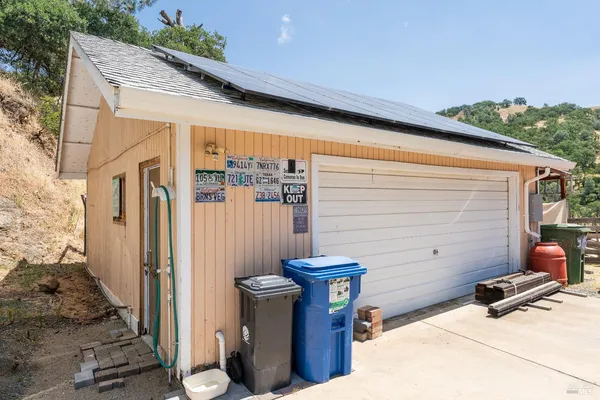 a view of a chair and table in the backyard