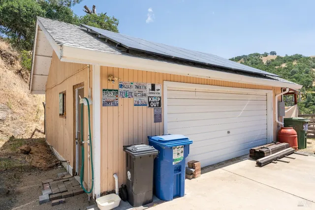 a view of a chair and table in the backyard