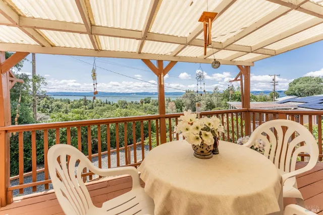 a view of a chair and tables in the balcony