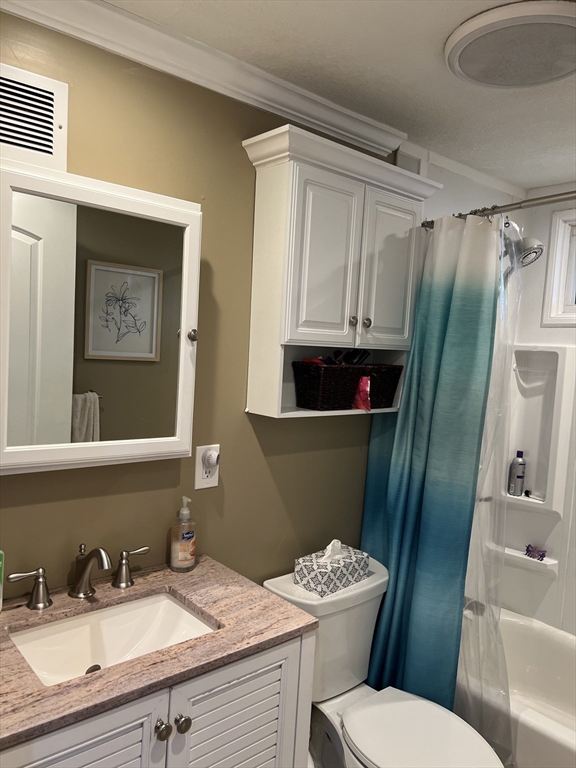 18 Shirley Road Springfield, MA 01109 - Photo 14 of 39 a bathroom with a sink a mirror a toilet and bathtub