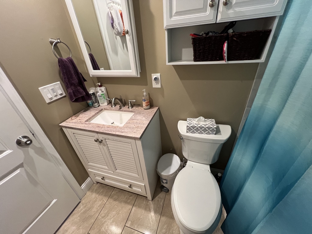 18 Shirley Road Springfield, MA 01109 - Photo 16 of 39 a bathroom with a toilet sink and mirror