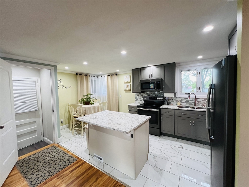 18 Shirley Road Springfield, MA 01109 - Photo 17 of 39 a kitchen with a refrigerator and a sink