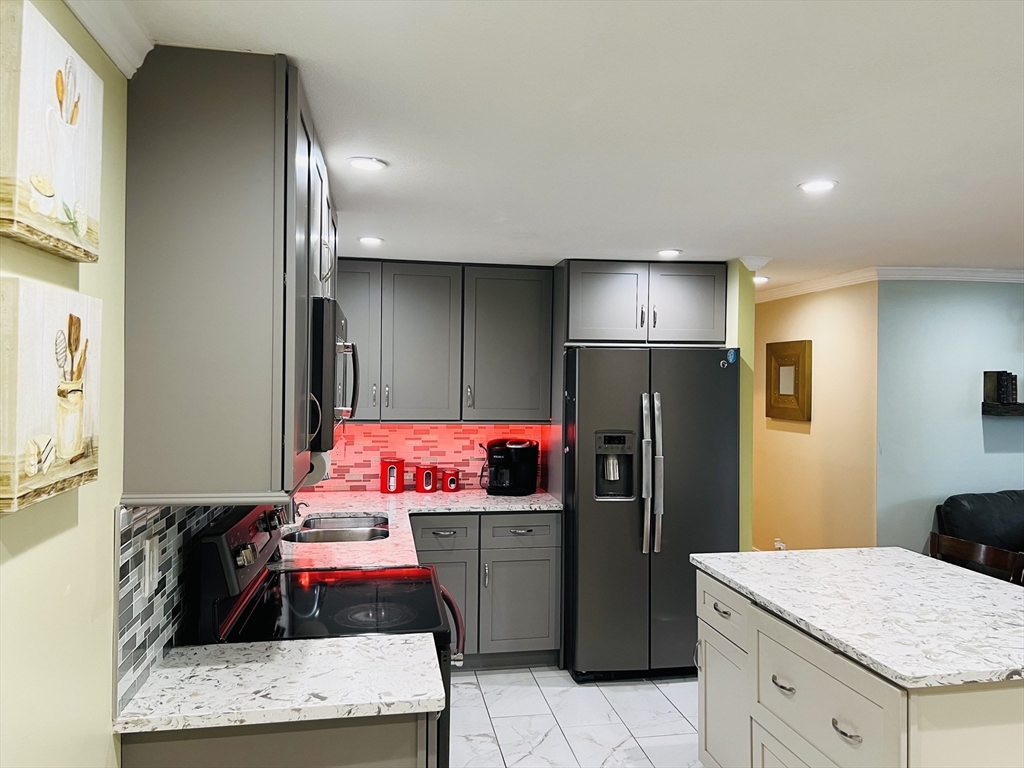 18 Shirley Road Springfield, MA 01109 - Photo 18 of 39 a kitchen with a refrigerator and a stove top oven