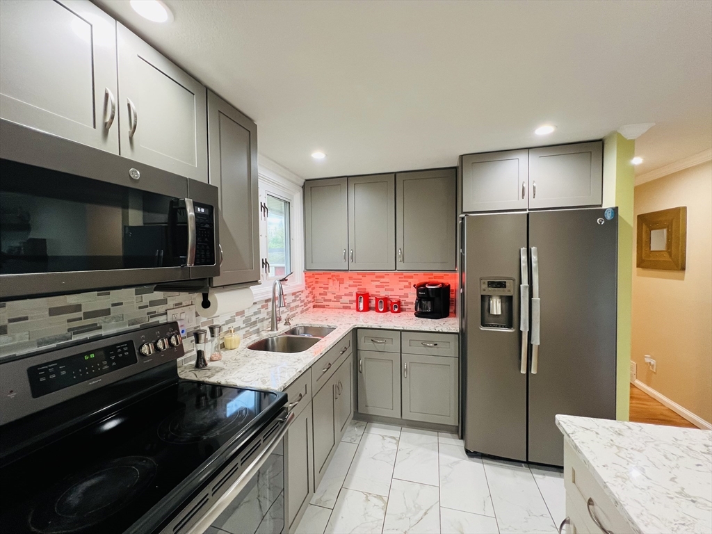 18 Shirley Road Springfield, MA 01109 - Photo 19 of 39 a kitchen with a sink stainless steel appliances and cabinets