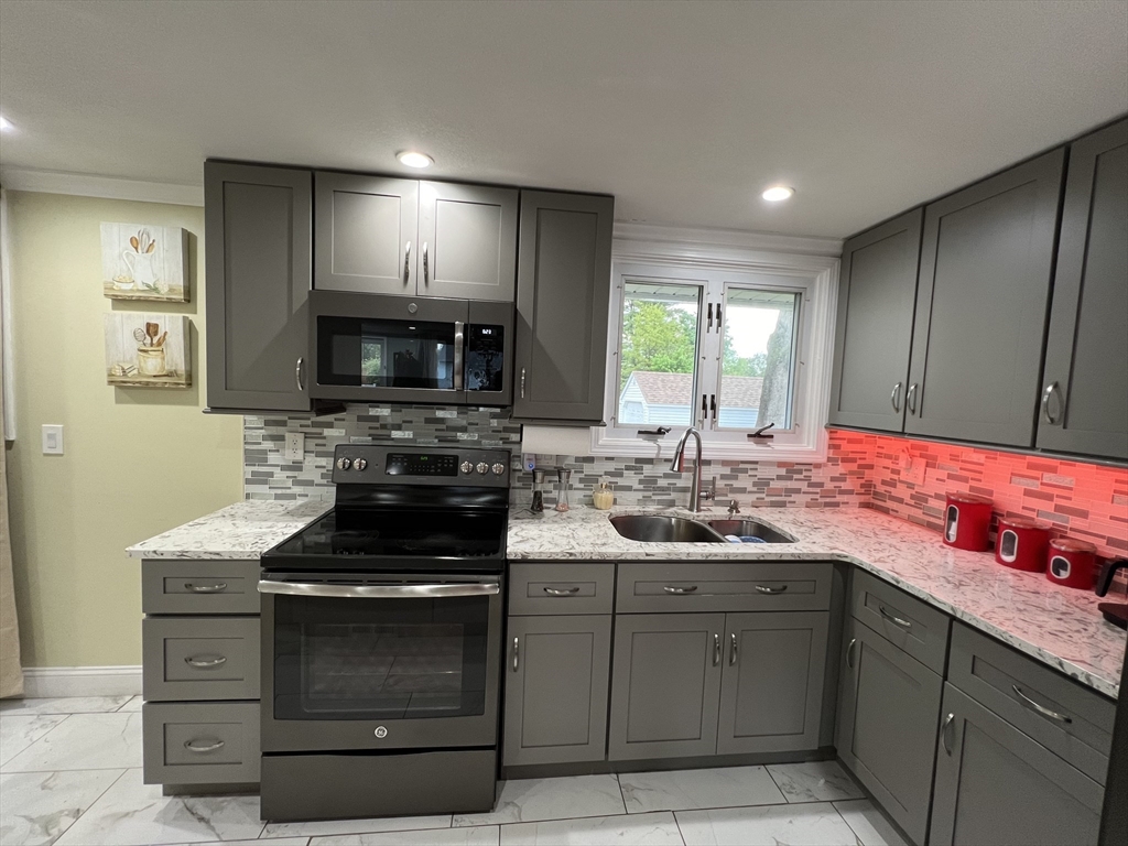 18 Shirley Road Springfield, MA 01109 - Photo 21 of 39 a kitchen with a sink stove and microwave