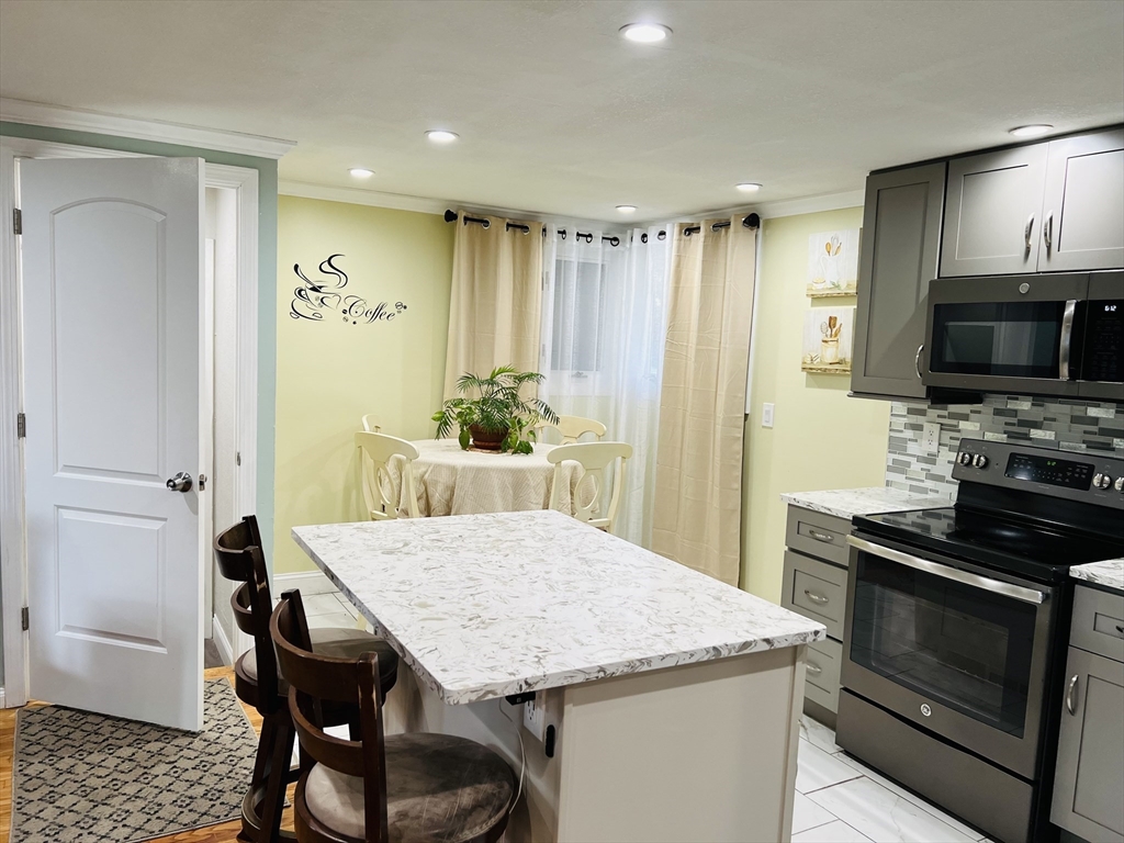18 Shirley Road Springfield, MA 01109 - Photo 23 of 39 a kitchen with a table and chairs in it