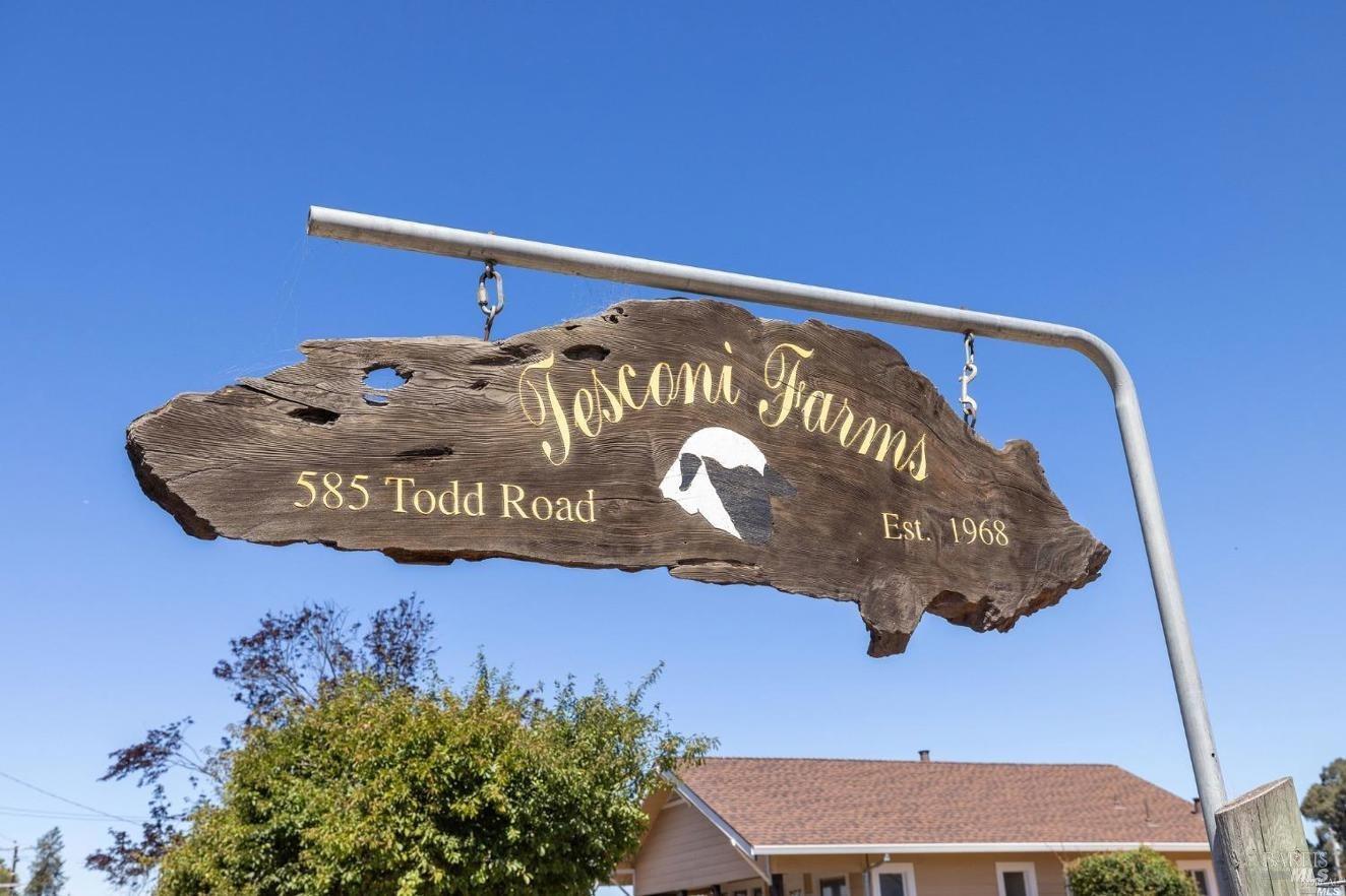 a blue sign sitting on top of a wooden floor