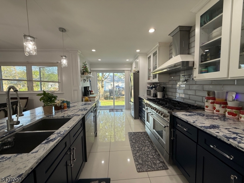 5 Appleman Road Somerset, NJ 08873 - Photo 10 of 12 a kitchen with stainless steel appliances granite countertop sink stove and cabinets