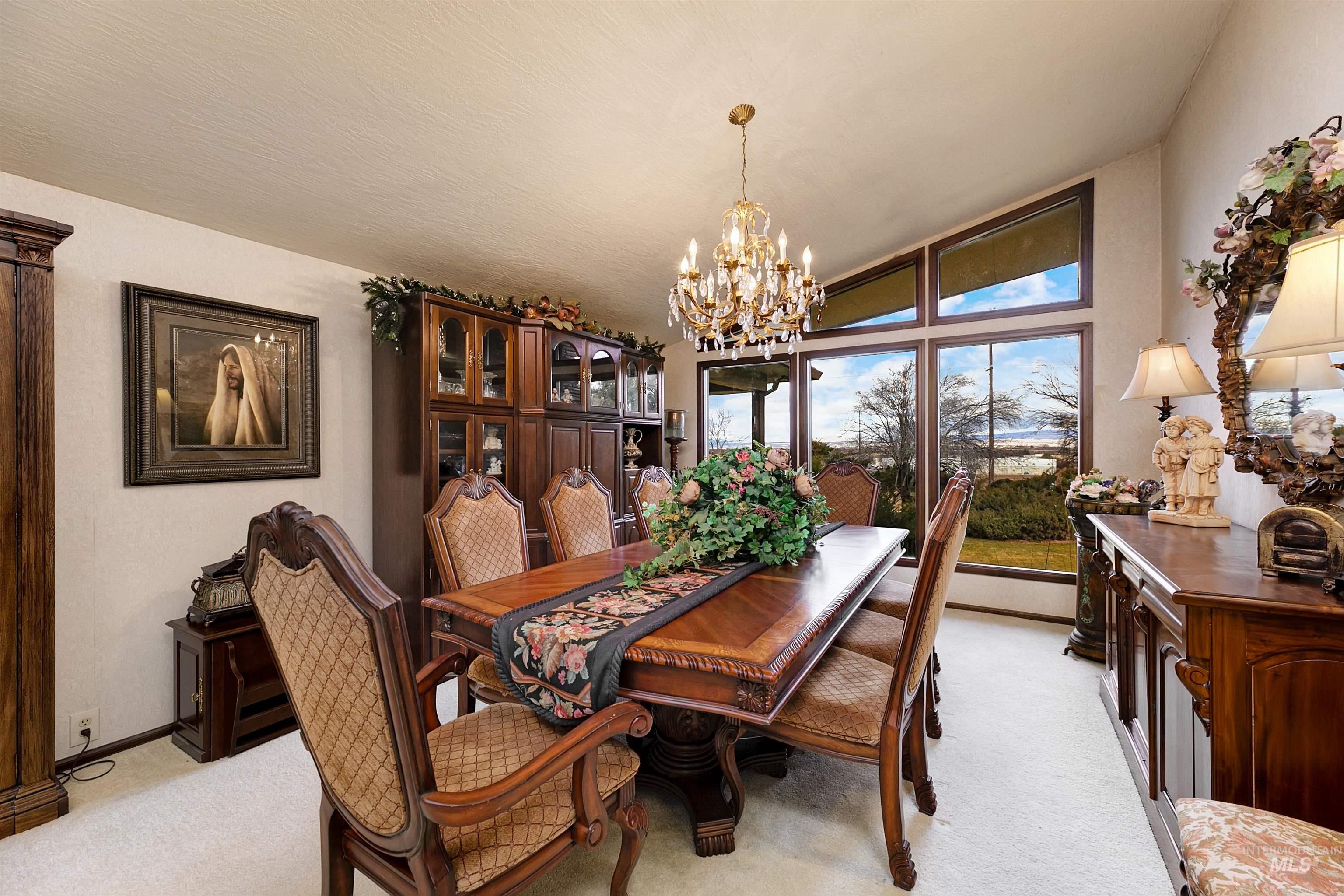 10030 West Stardust Drive Boise, ID 83709 - Photo 18 of 50 Dining area with light colored carpet and suspended lighting