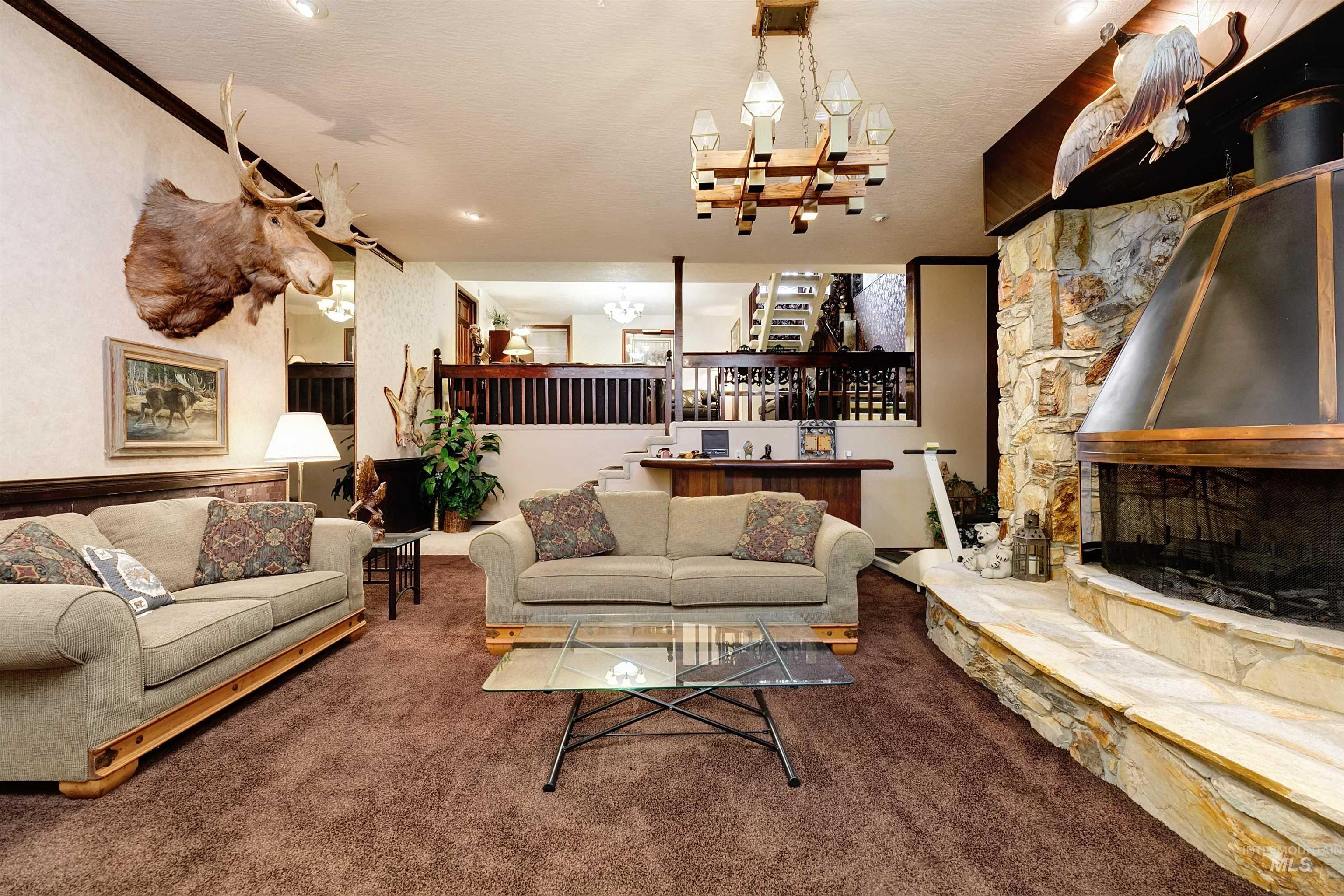 10030 West Stardust Drive Boise, ID 83709 - Photo 37 of 50 Living room with carpet floors, a fireplace, and a textured ceiling