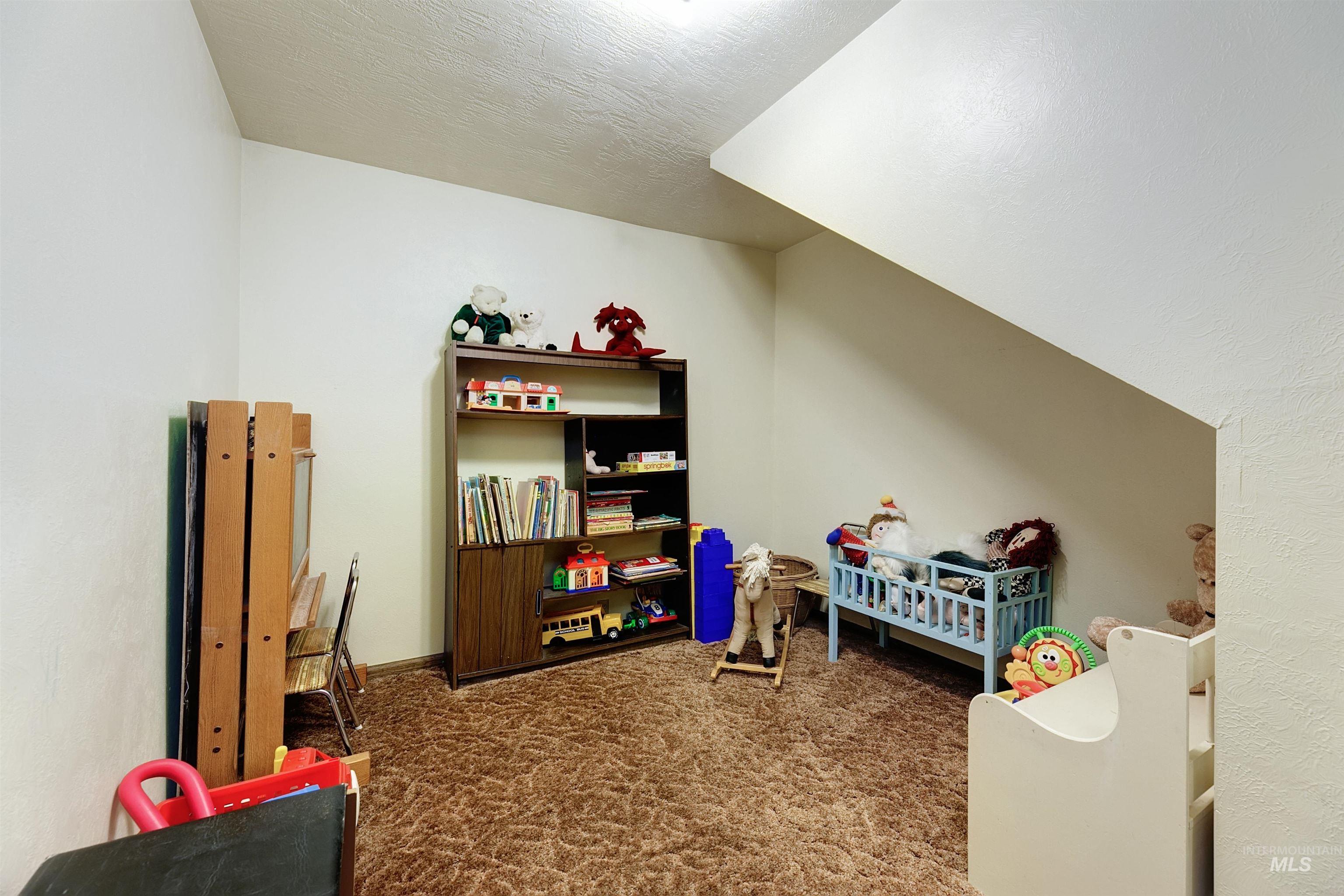 10030 West Stardust Drive Boise, ID 83709 - Photo 40 of 50 Game room featuring dark carpet and a textured ceiling