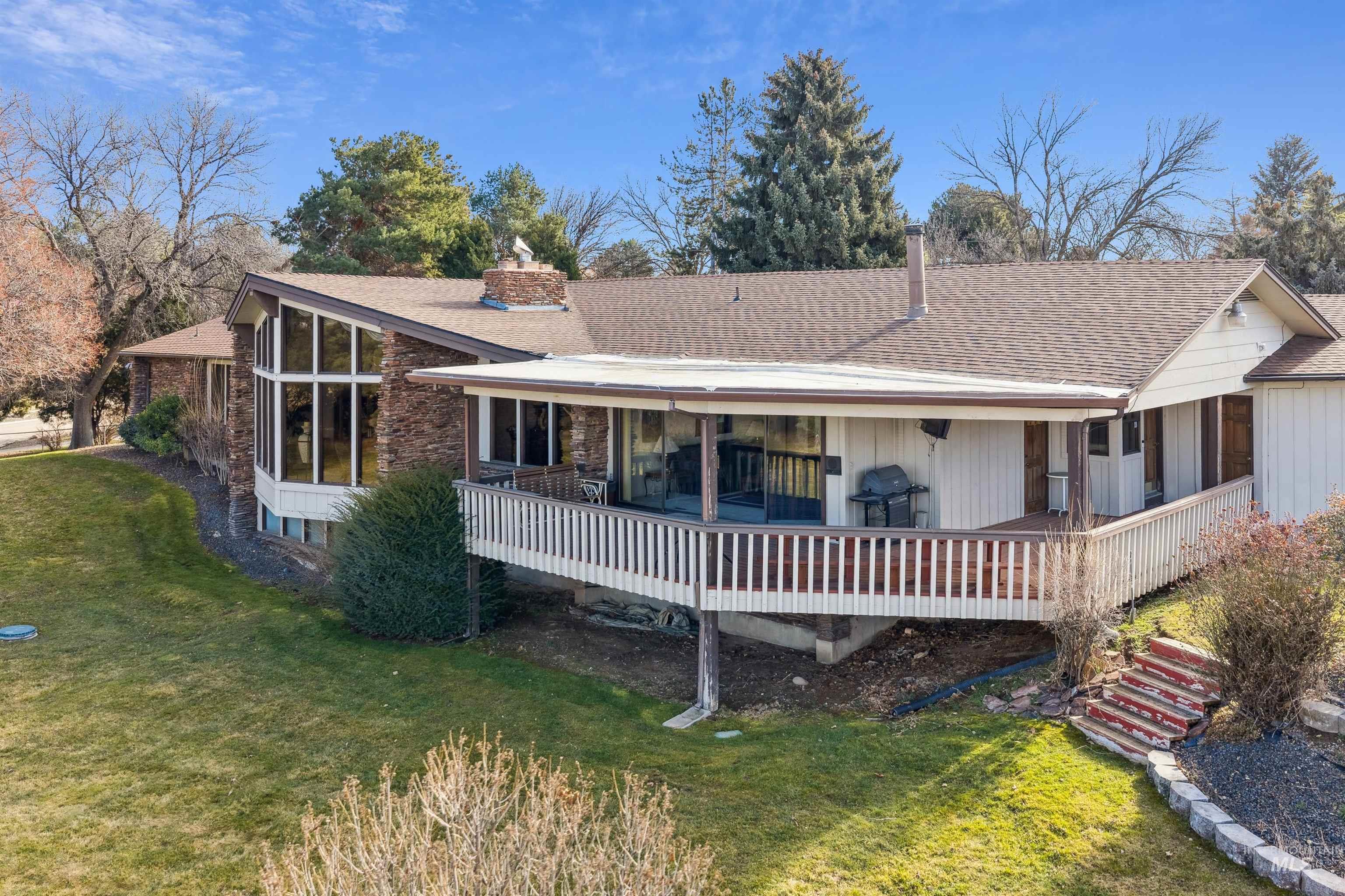 10030 West Stardust Drive Boise, ID 83709 - Photo 46 of 50 Back of property with a chimney, a yard, and a shingled roof