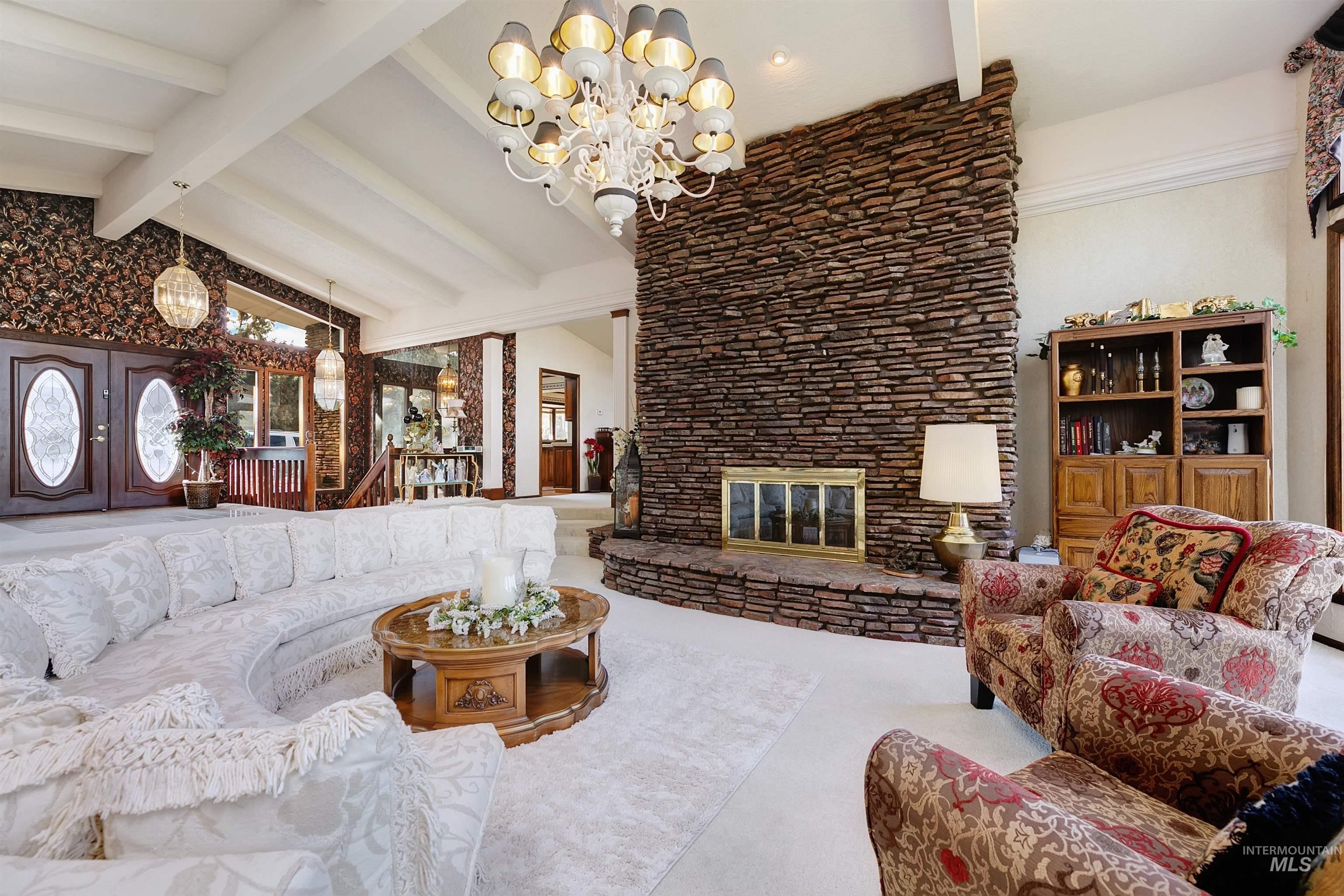 10030 West Stardust Drive Boise, ID 83709 - Photo 9 of 50 Living area featuring a chandelier and a glass covered fireplace