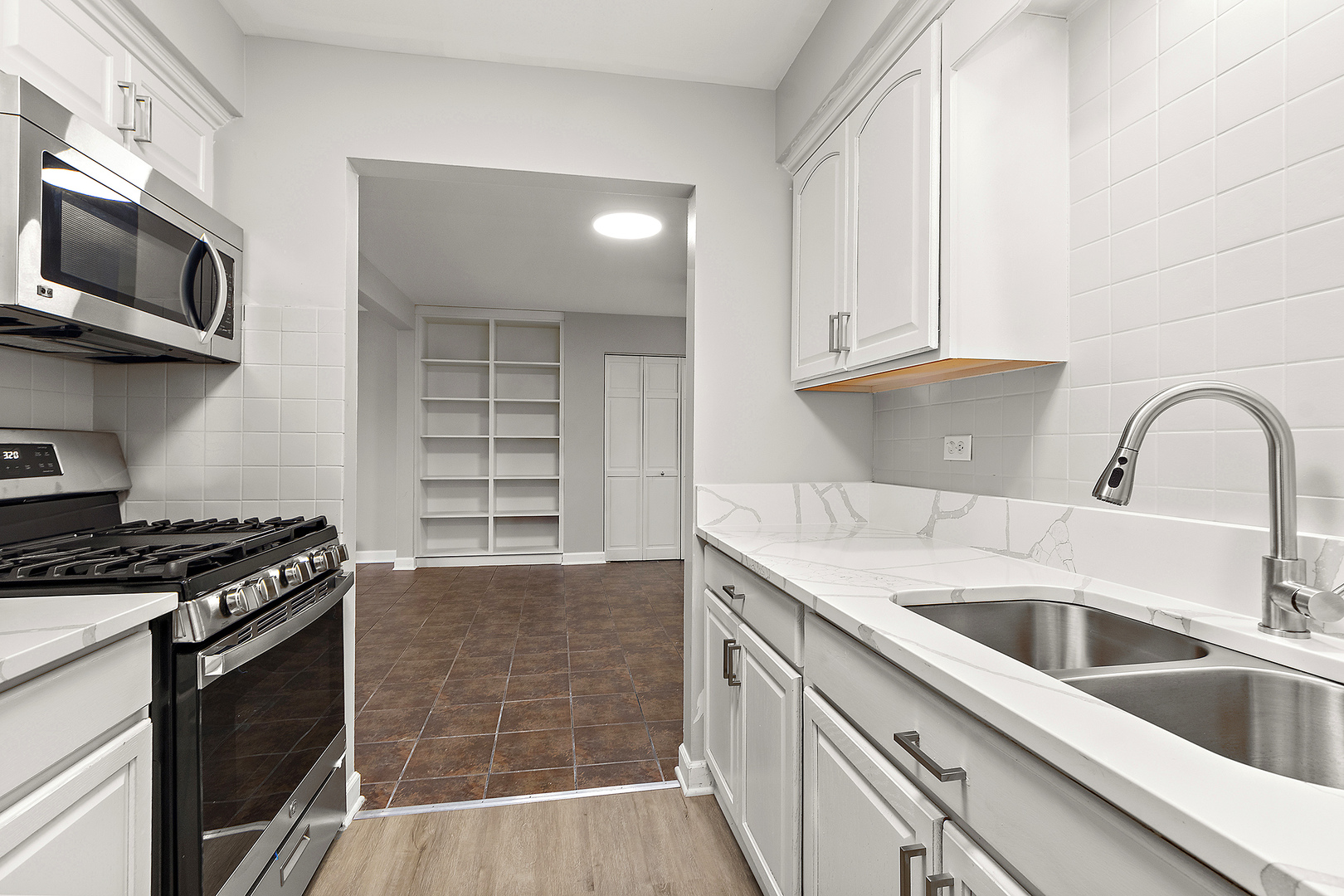 254 East Bailey Road, Unit M Naperville, IL 60565 - Photo 11 of 27 a kitchen with granite countertop a stove and a sink