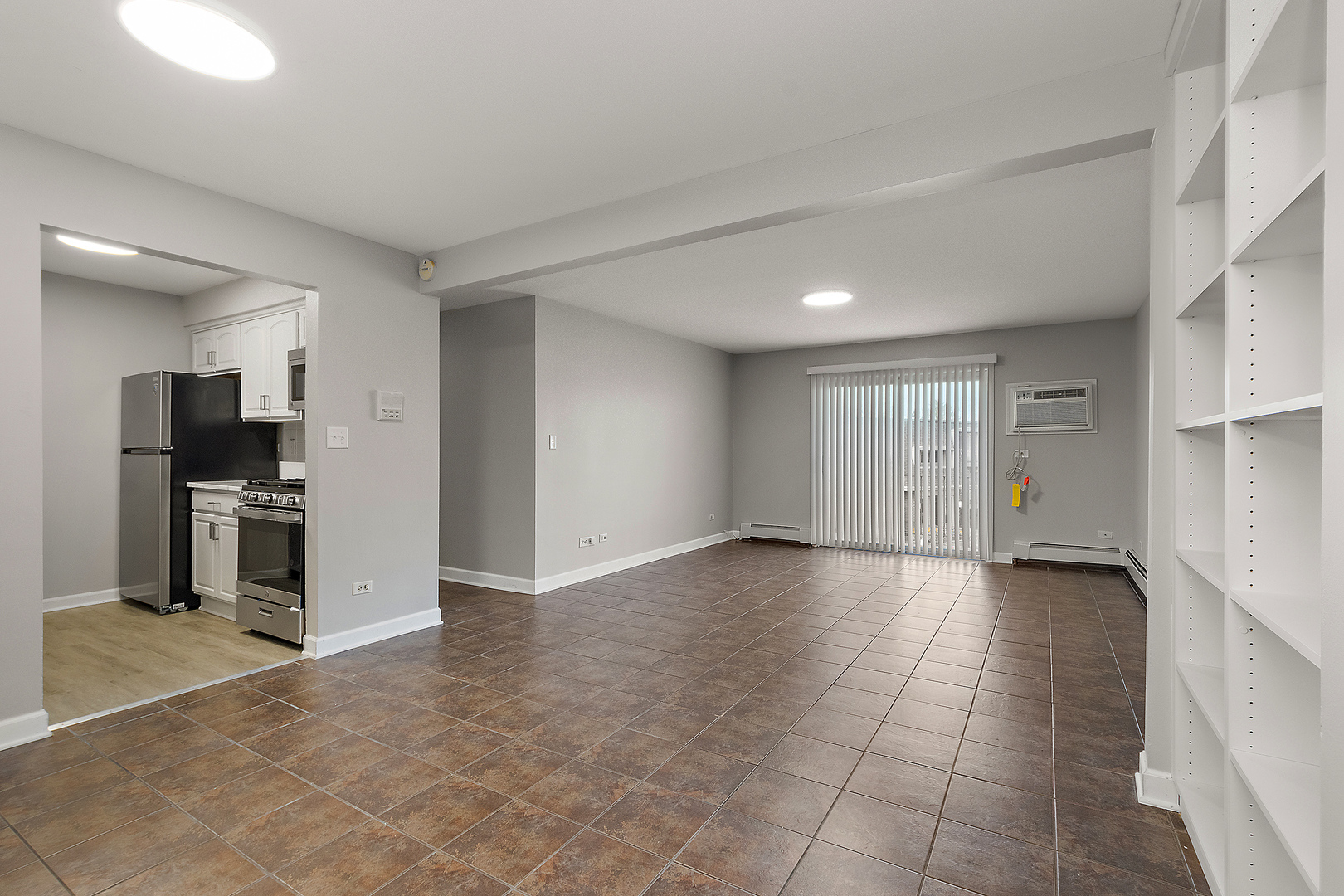 254 East Bailey Road, Unit M Naperville, IL 60565 - Photo 4 of 27 a view of a kitchen with a sink and a refrigerator