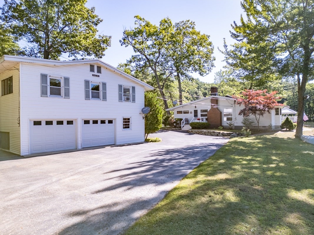 116 Shelters Road Groton, MA 01450 - Photo 1 of 41 a front view of a house with a yard and garage
