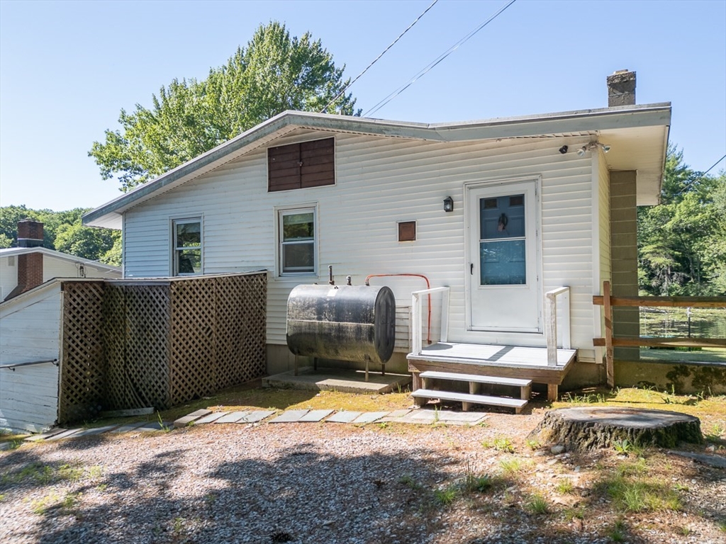 116 Shelters Road Groton, MA 01450 - Photo 32 of 41 a backyard of a house with barbeque oven and outdoor seating