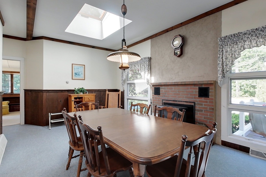 116 Shelters Road Groton, MA 01450 - Photo 6 of 41 a view of a dining room with furniture and a fireplace