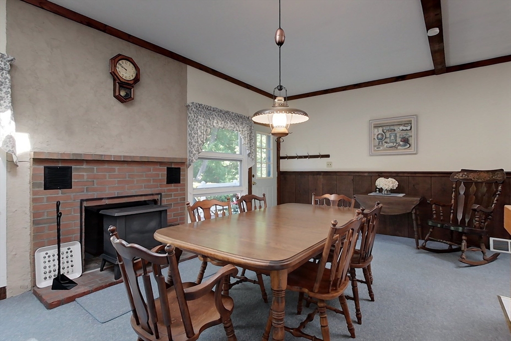 116 Shelters Road Groton, MA 01450 - Photo 7 of 41 a view of a dining room with furniture and a chandelier
