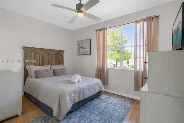 a bedroom with a dresser and a chandelier