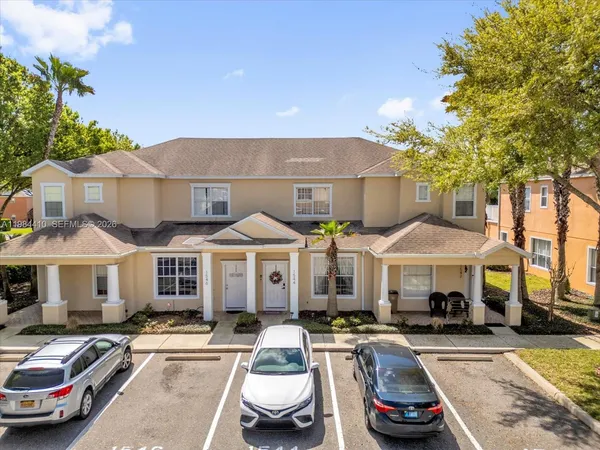 a front view of a house with car parked
