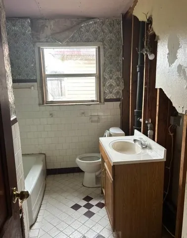 a bathroom with a sink toilet and a mirror