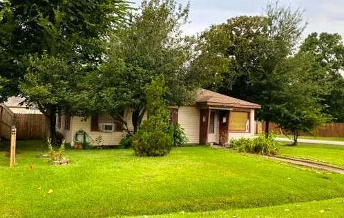 a front view of house with yard and green space