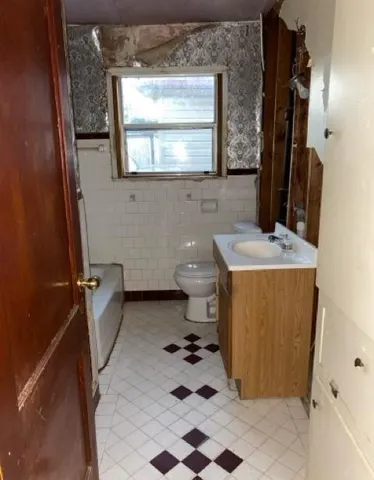 a bathroom with a sink a toilet and a mirror