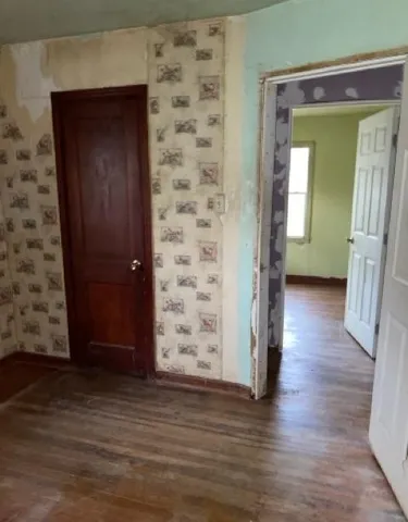 wooden floor with a bench in a room